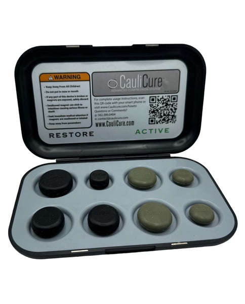 Caulicure Advanced Compression System. Featured 4 black restore magnetic discs and Four Green Active Discs in a black case with a gray tray.